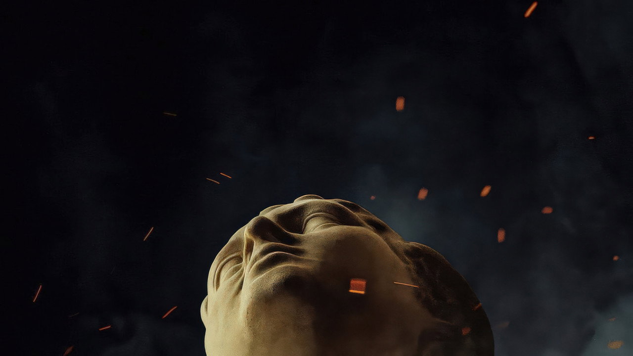 A stone face beneath drifting embers in Christopher Nolan's The Odyssey